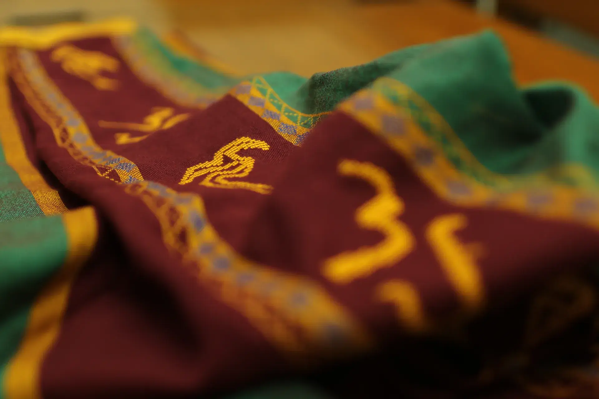 The UP sablay resting on a graduate's shoulder