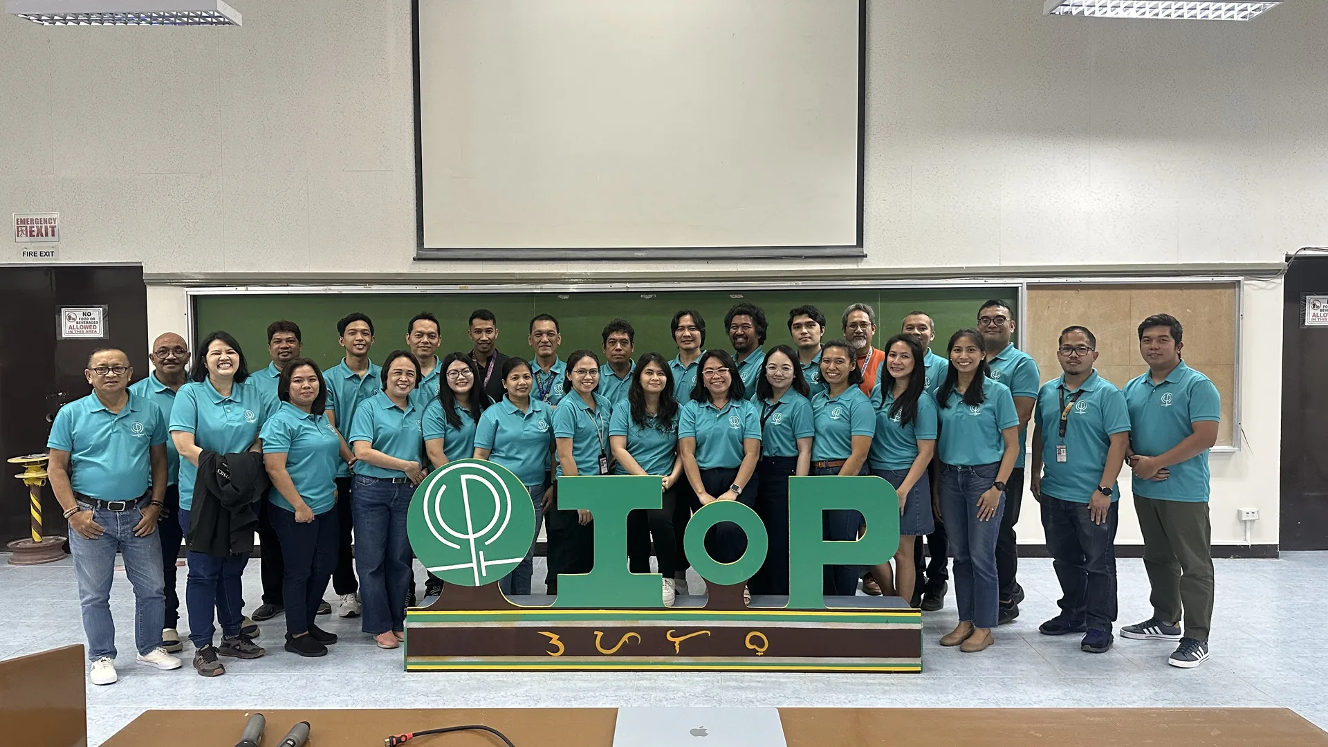 Faculty and staff of the Institute of Physics gathered behind the IOP letters