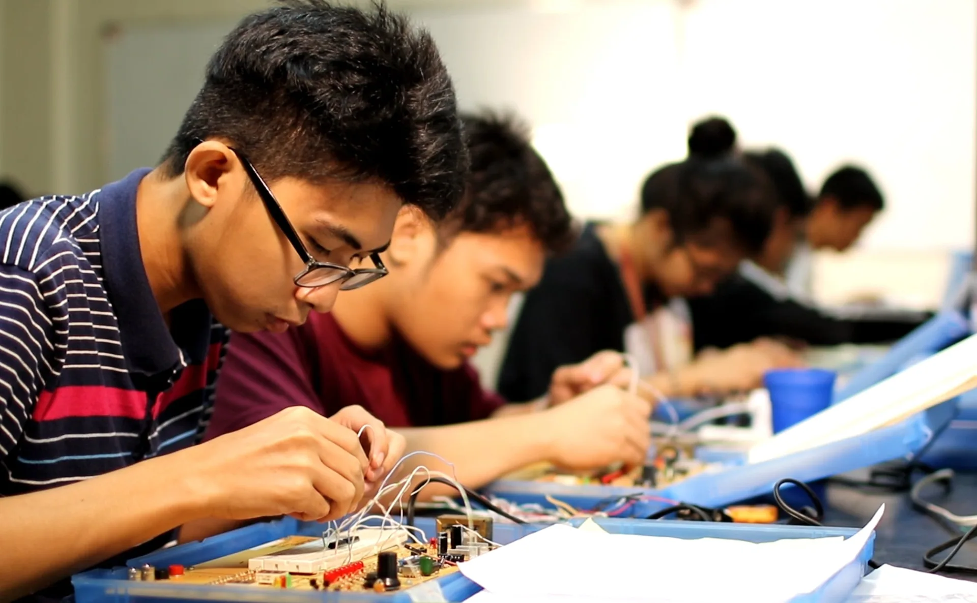 Physics students assembling circuits in a UPLB laboratory